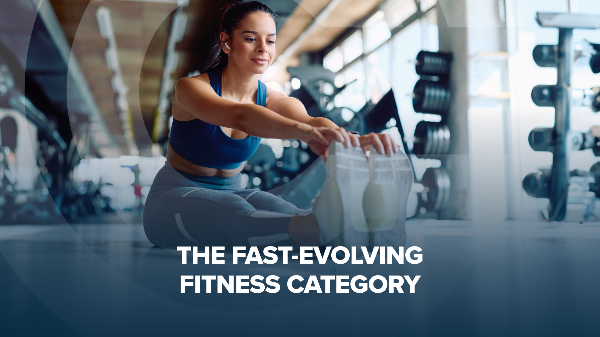 The fast evolving fitness category blog post header image A pretty woman wearing earbuds stretches her hamstrings in a gym